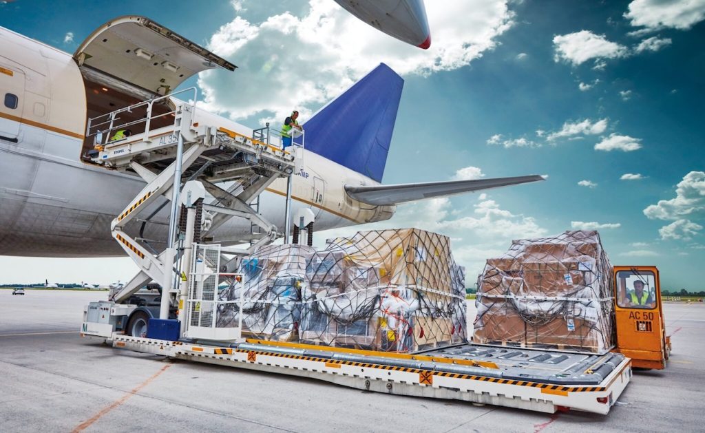 Air freight cargo loading operations Iraq - International cargo aircraft at Baghdad Erbil airport with freight forwarding logistics coordination