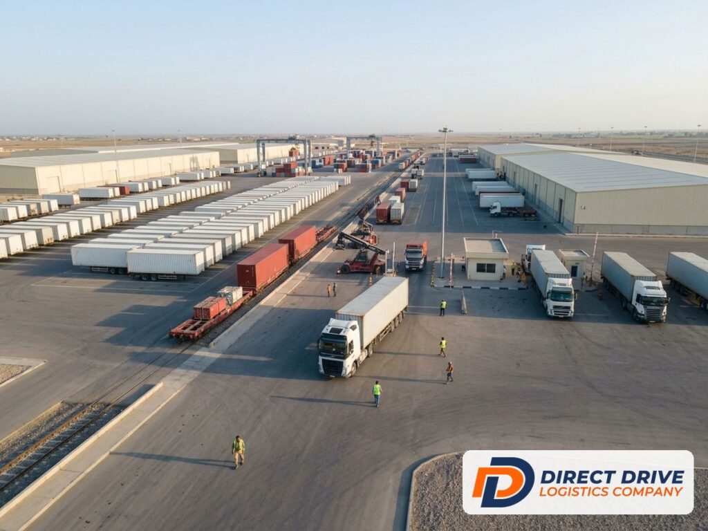 Aerial view of a modern logistics park with warehouses, container trailers and a rail spur.